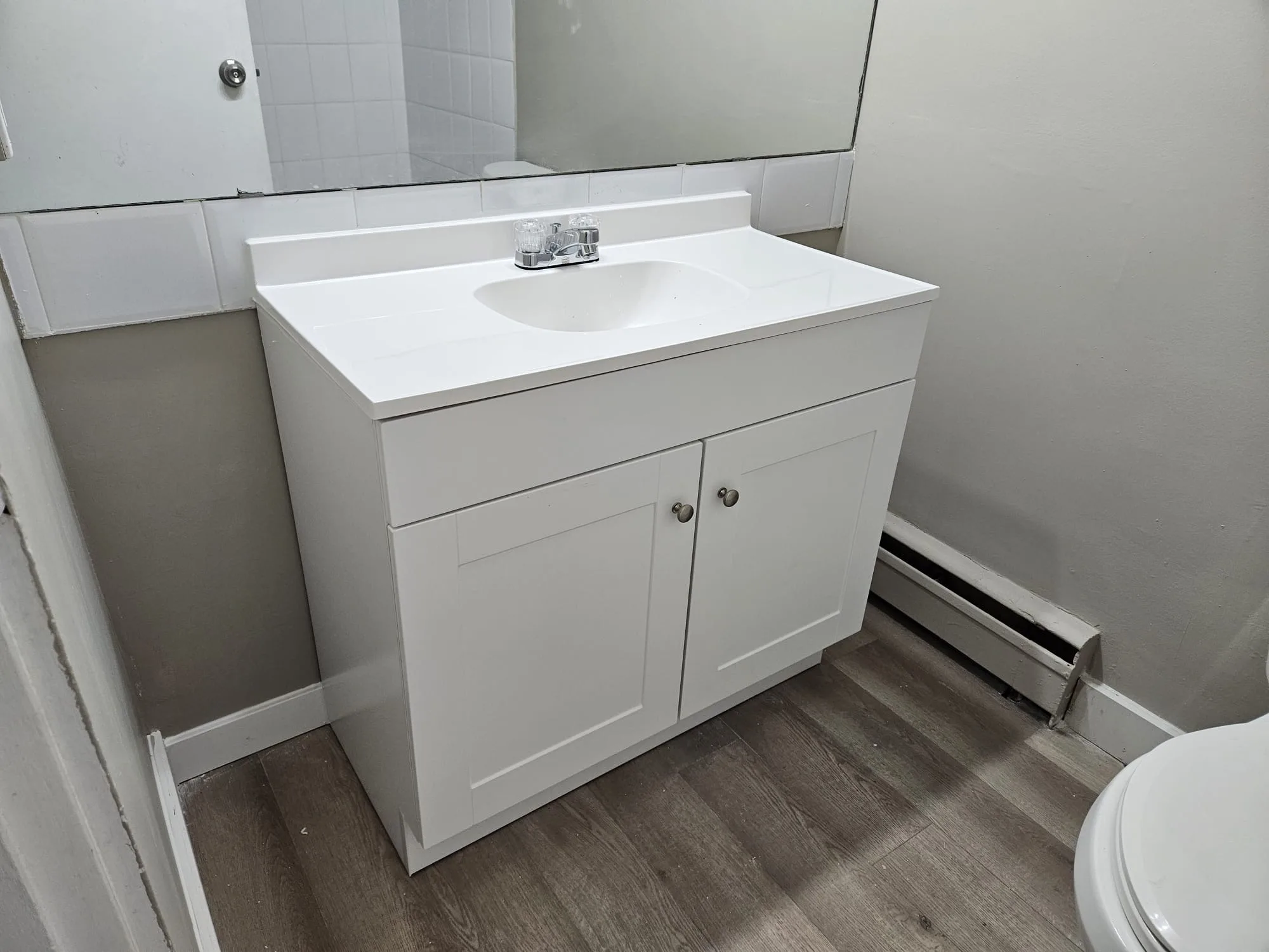 Bathroom Lvp Vanity Toilet — Stampede Flooring Calgary
