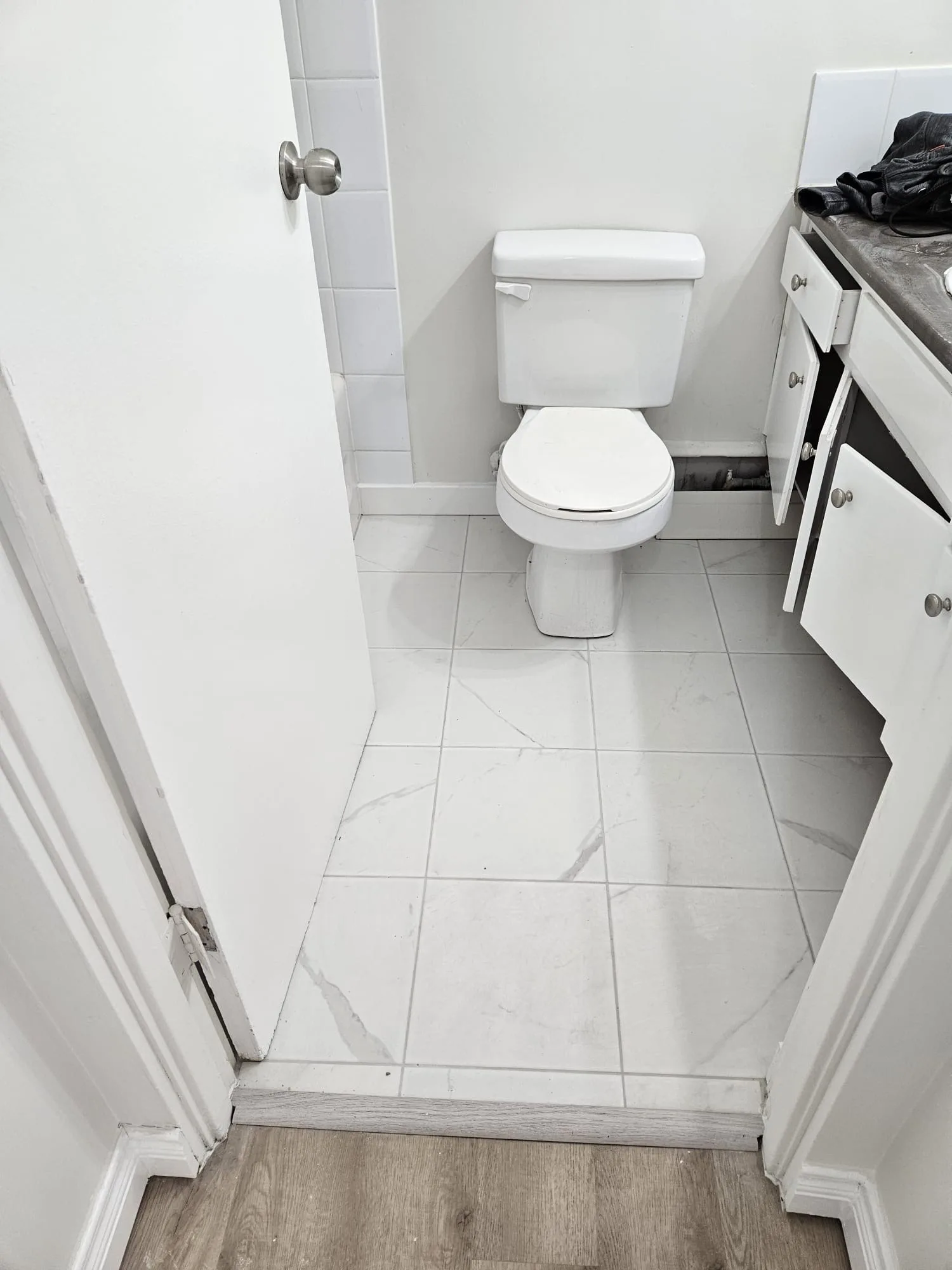 Bathroom Marble Tile Toilet — Stampede Flooring Calgary