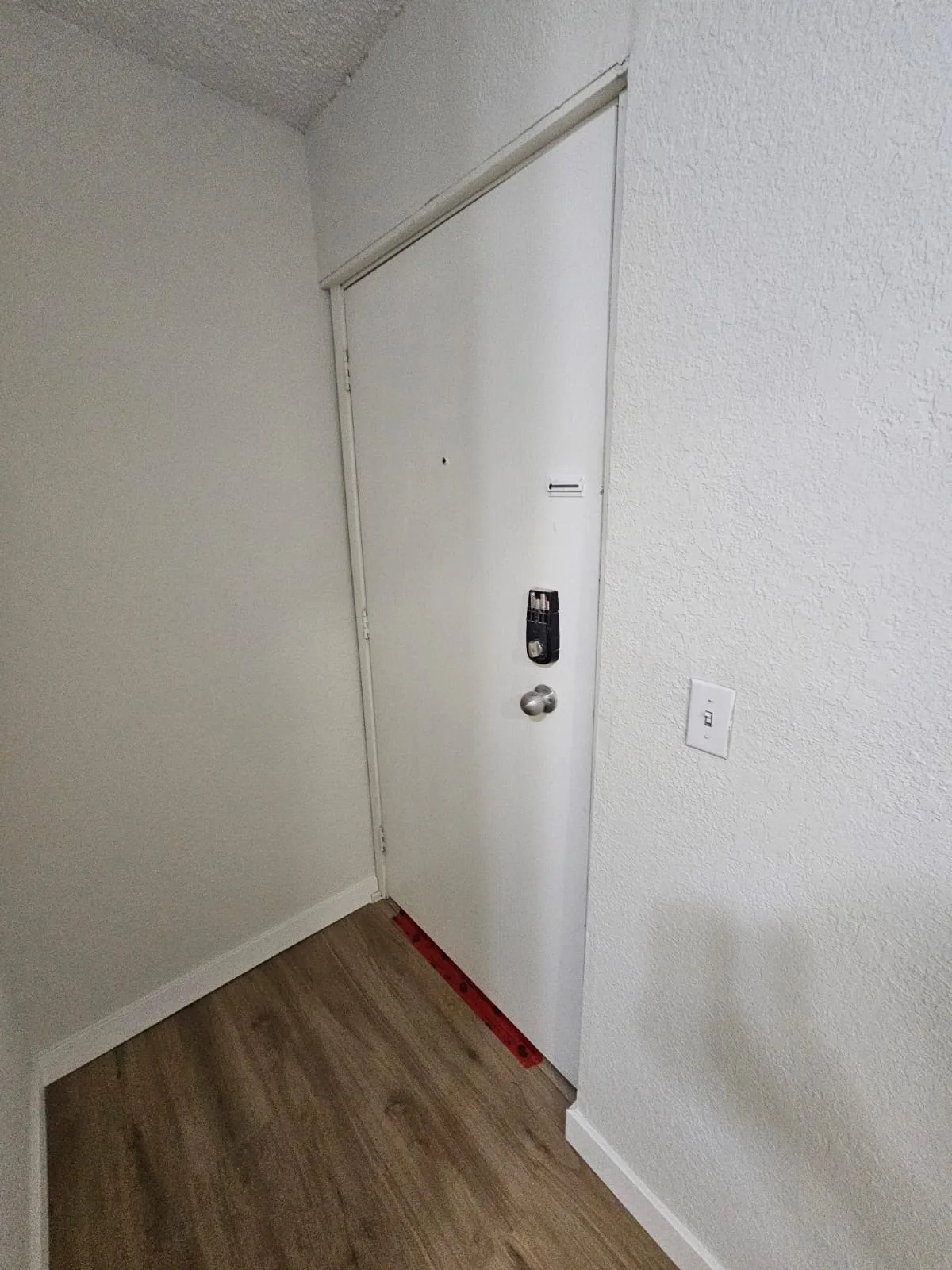 Lvp Apartment Entryway Door — Stampede Flooring Calgary