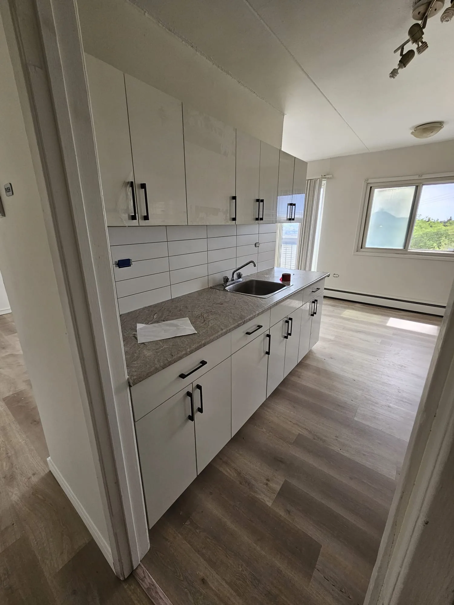 Lvp Kitchen White Cabinets Finished — Stampede Flooring Calgary