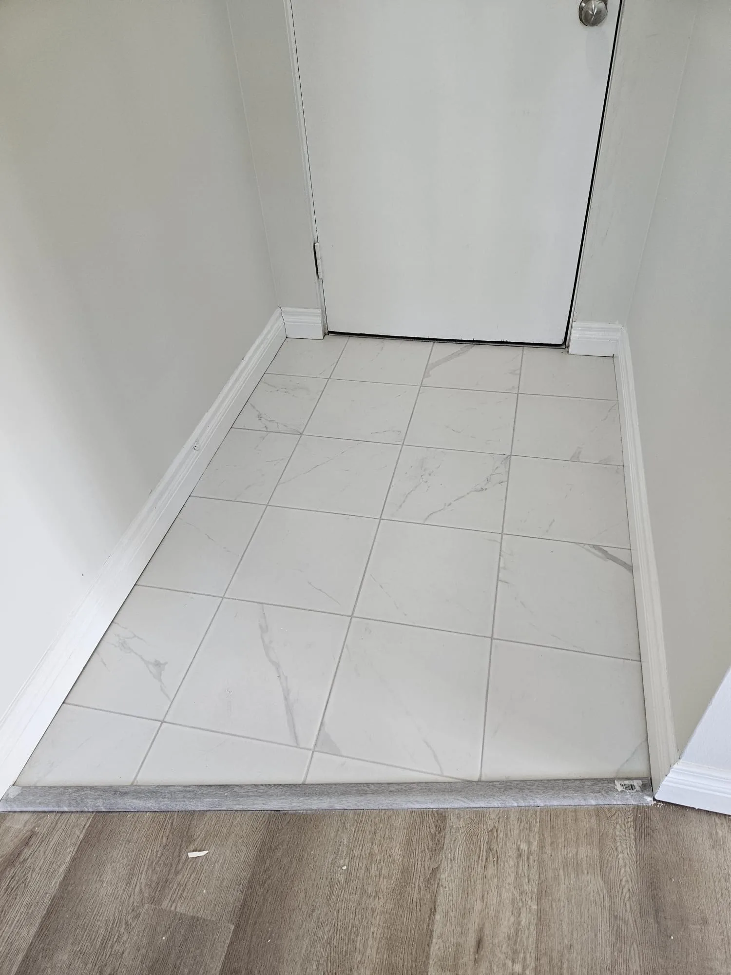 Tile Lvp Entryway Transition — Stampede Flooring Calgary