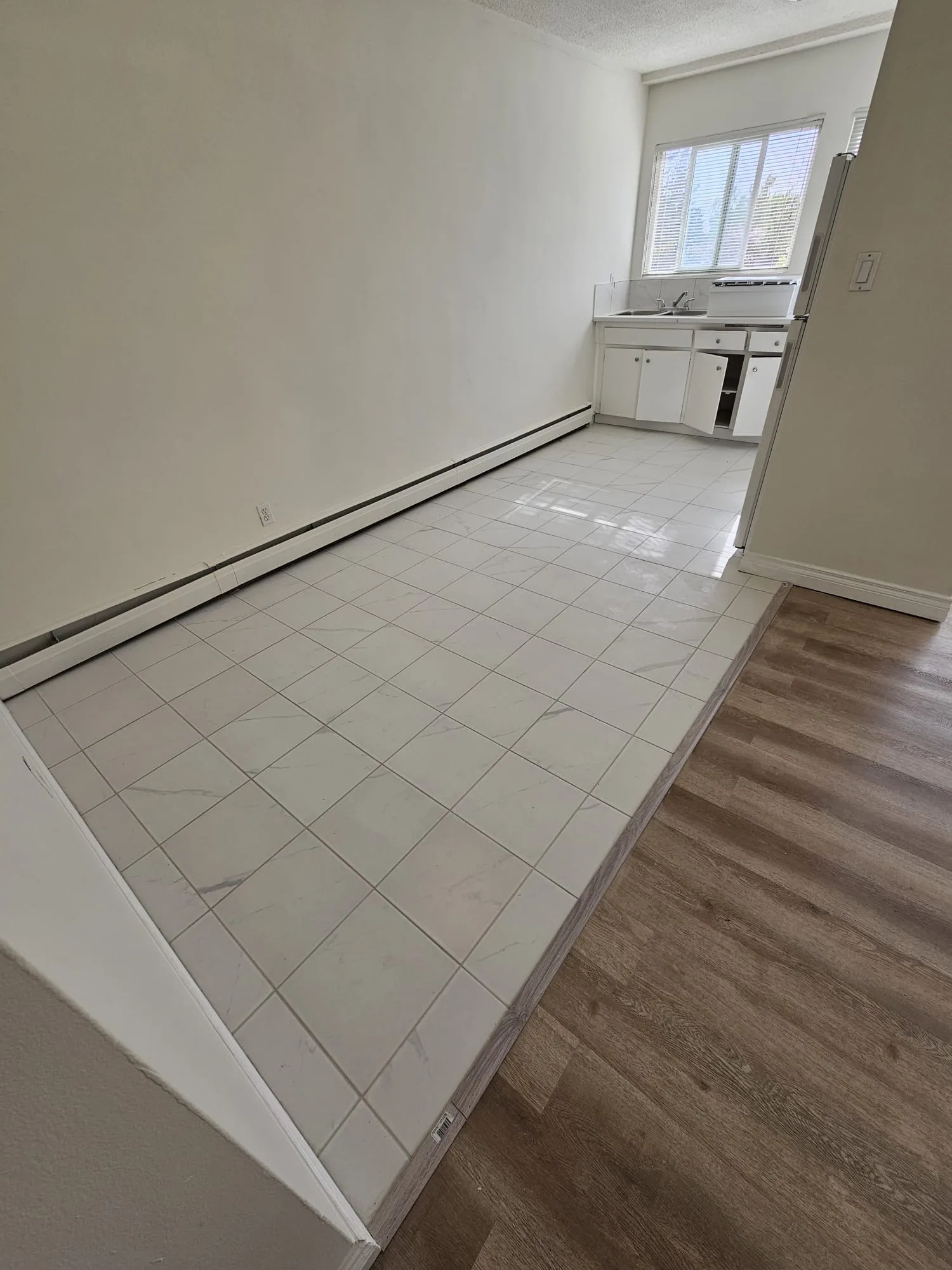 Tile Lvp Kitchen Transition Apartment — Stampede Flooring Calgary