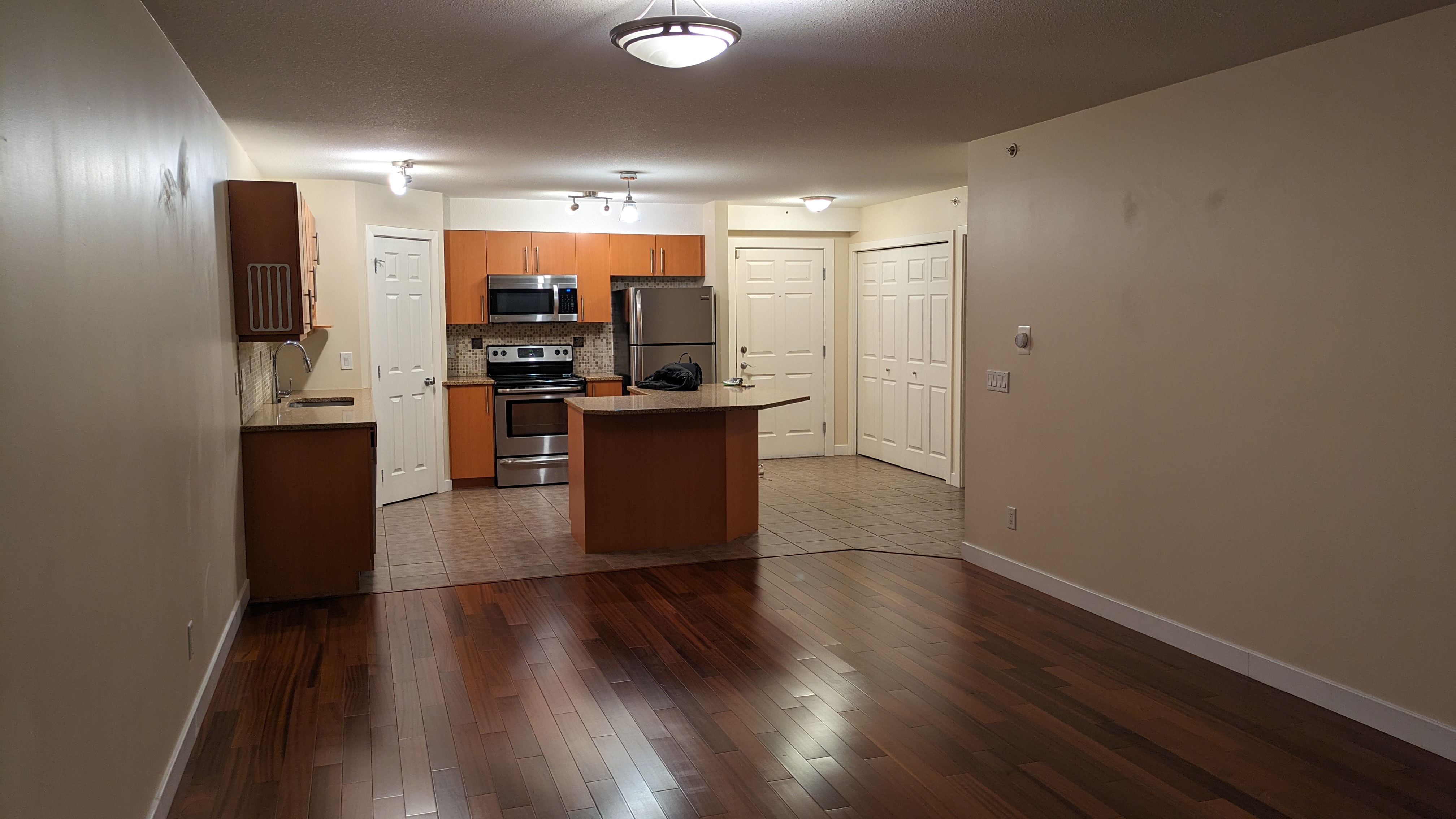 Engineered hardwood flooring installed in an NW Calgary living room — warm oak plank finish