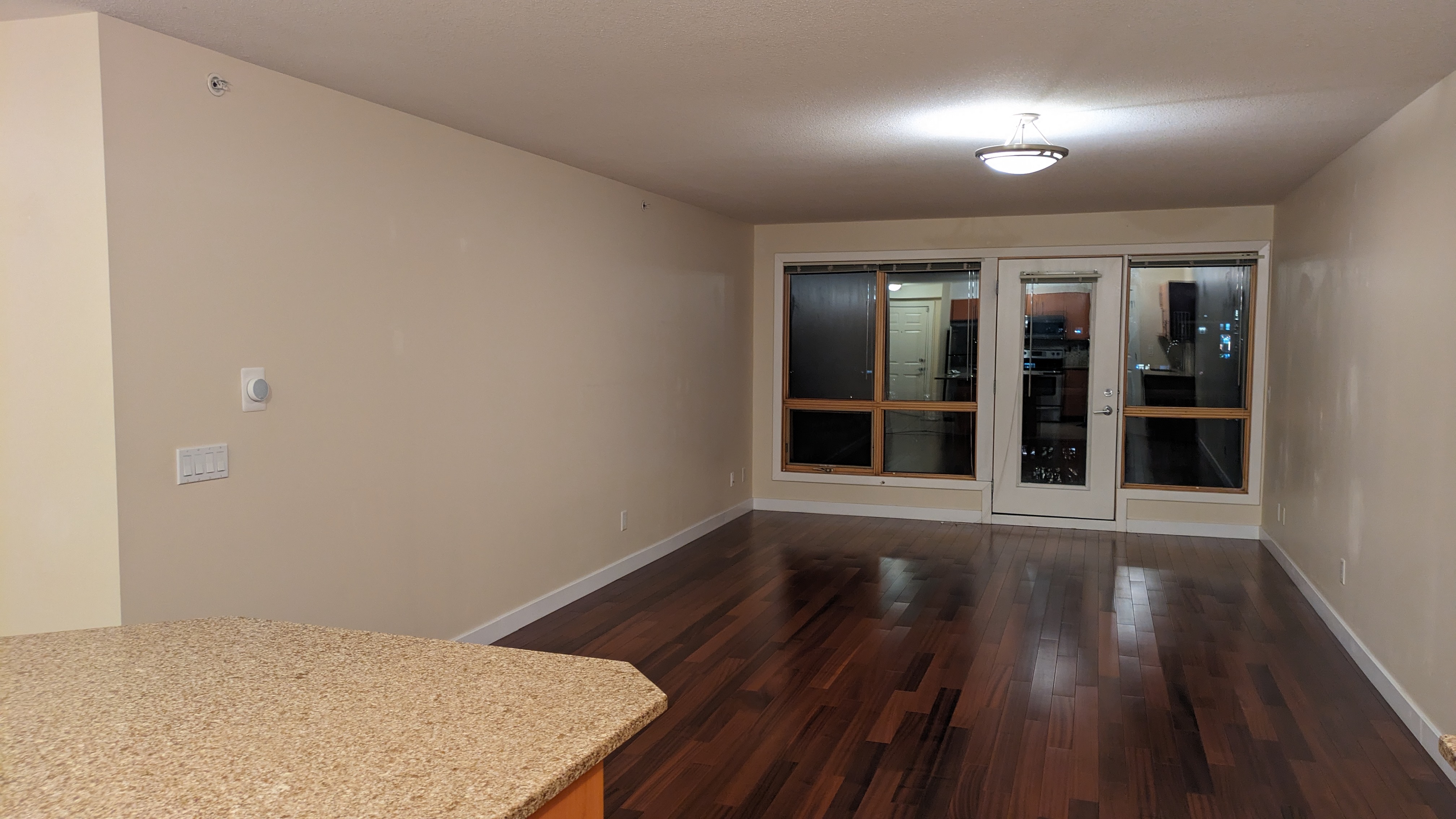 Solid hardwood flooring in a Calgary dining room — stained maple with clean transitions
