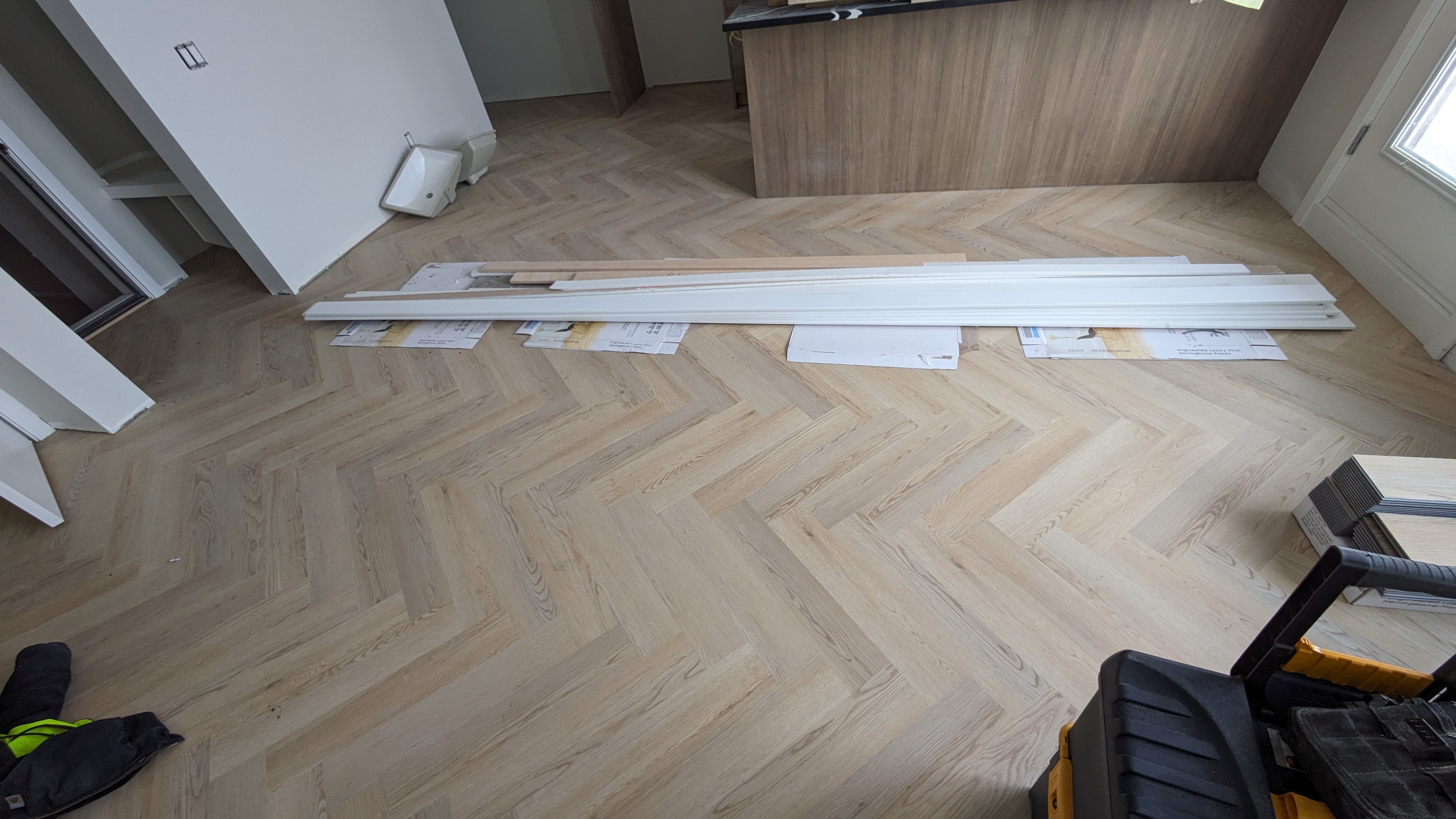 LVP flooring on the main floor of an Airdrie home — honey oak tone wide plank