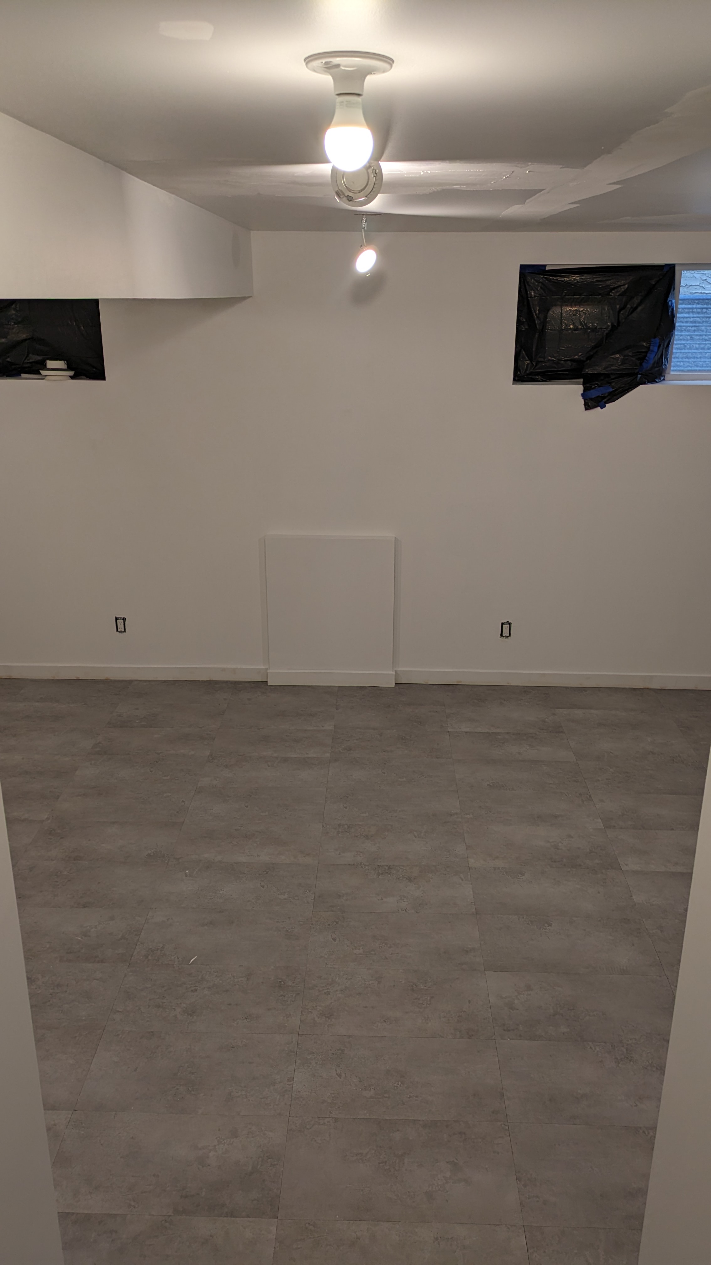 SPC rigid core waterproof flooring installed in a Calgary mudroom and hallway — durable wood-look