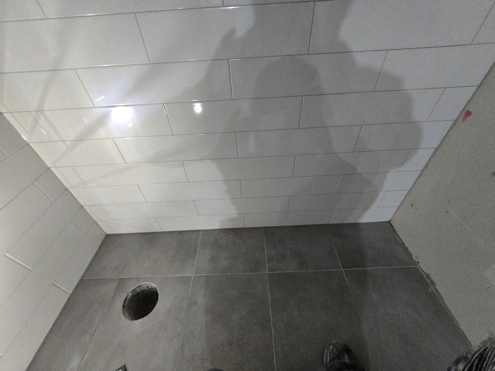 Large format porcelain tile flooring installed in a Calgary kitchen — modern grey with minimal grout lines