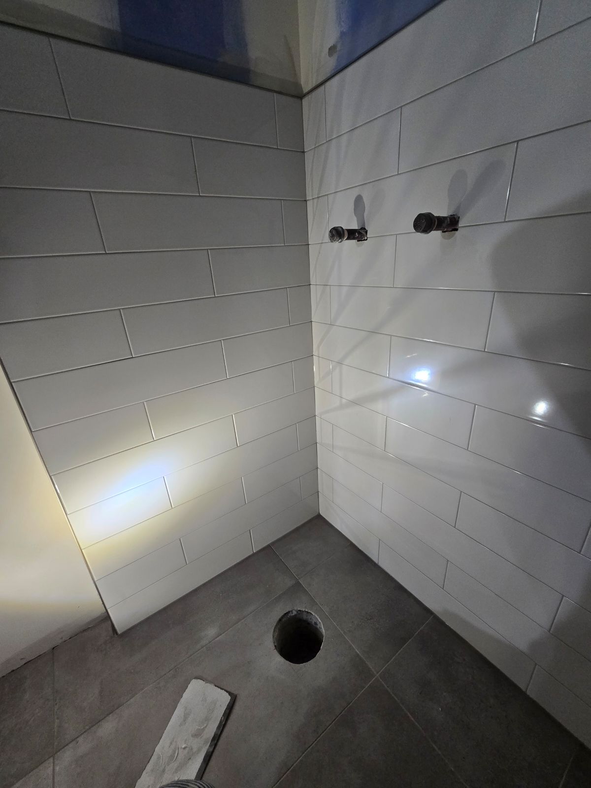 Bathroom tile installation in a Calgary home — porcelain floor tile and shower tile with heated floor system