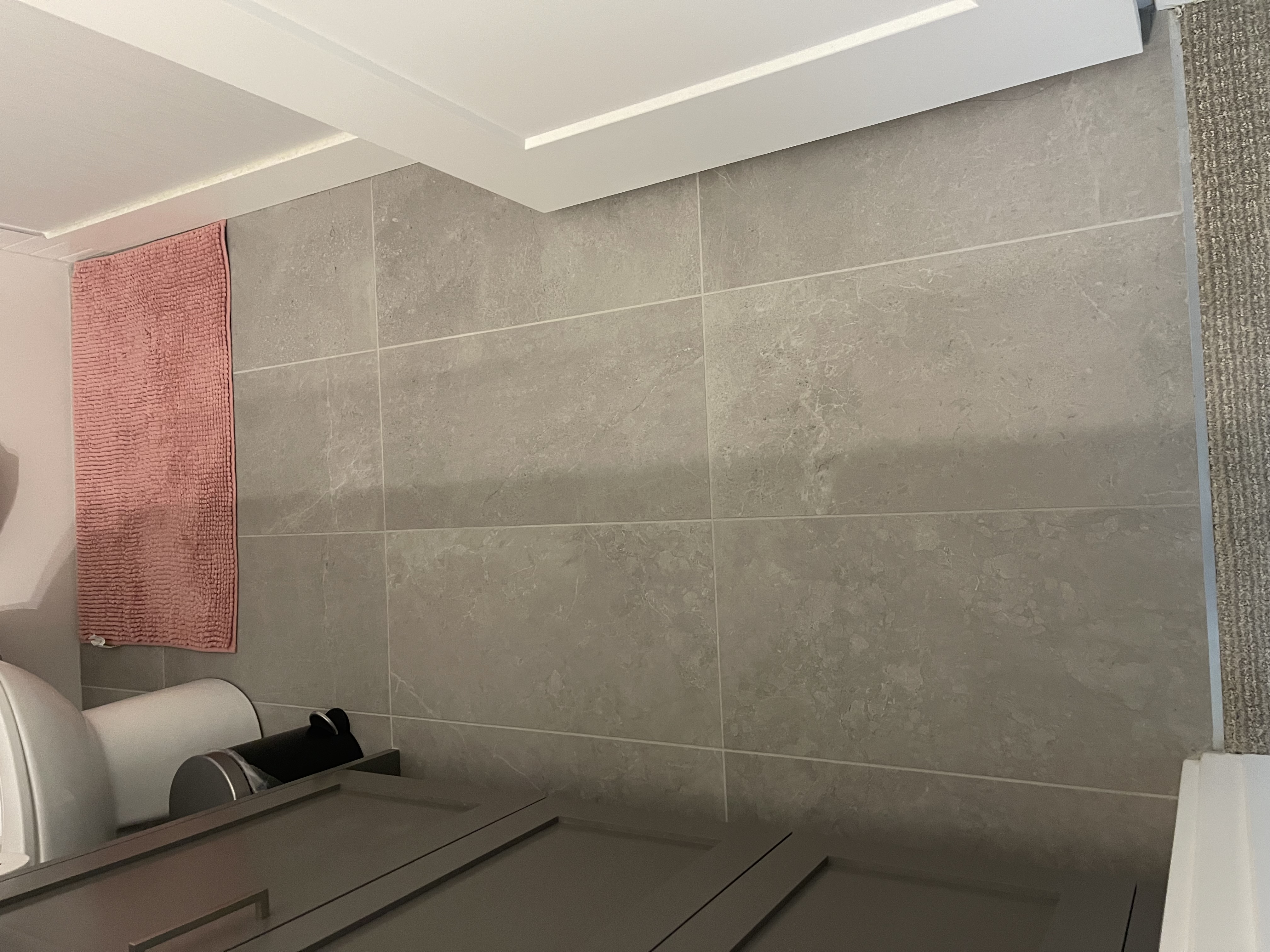 Entryway tile flooring in a Calgary NE home — large format tile with heated floor