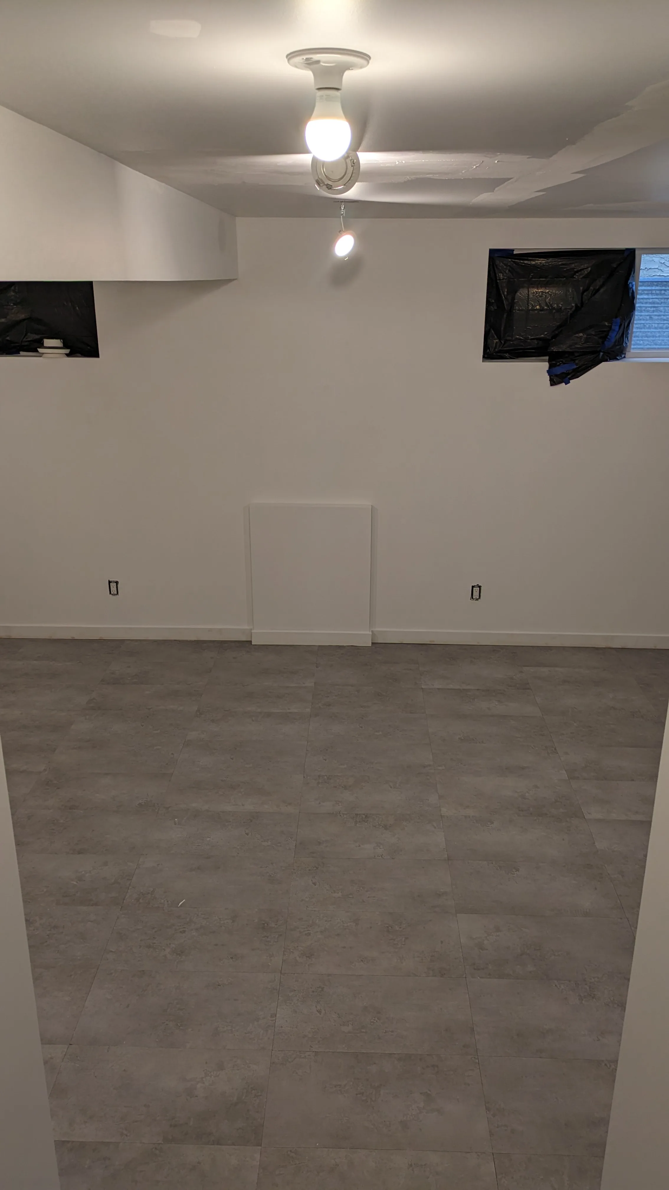 LVT luxury vinyl tile flooring installed in a Calgary basement — realistic wood-look finish