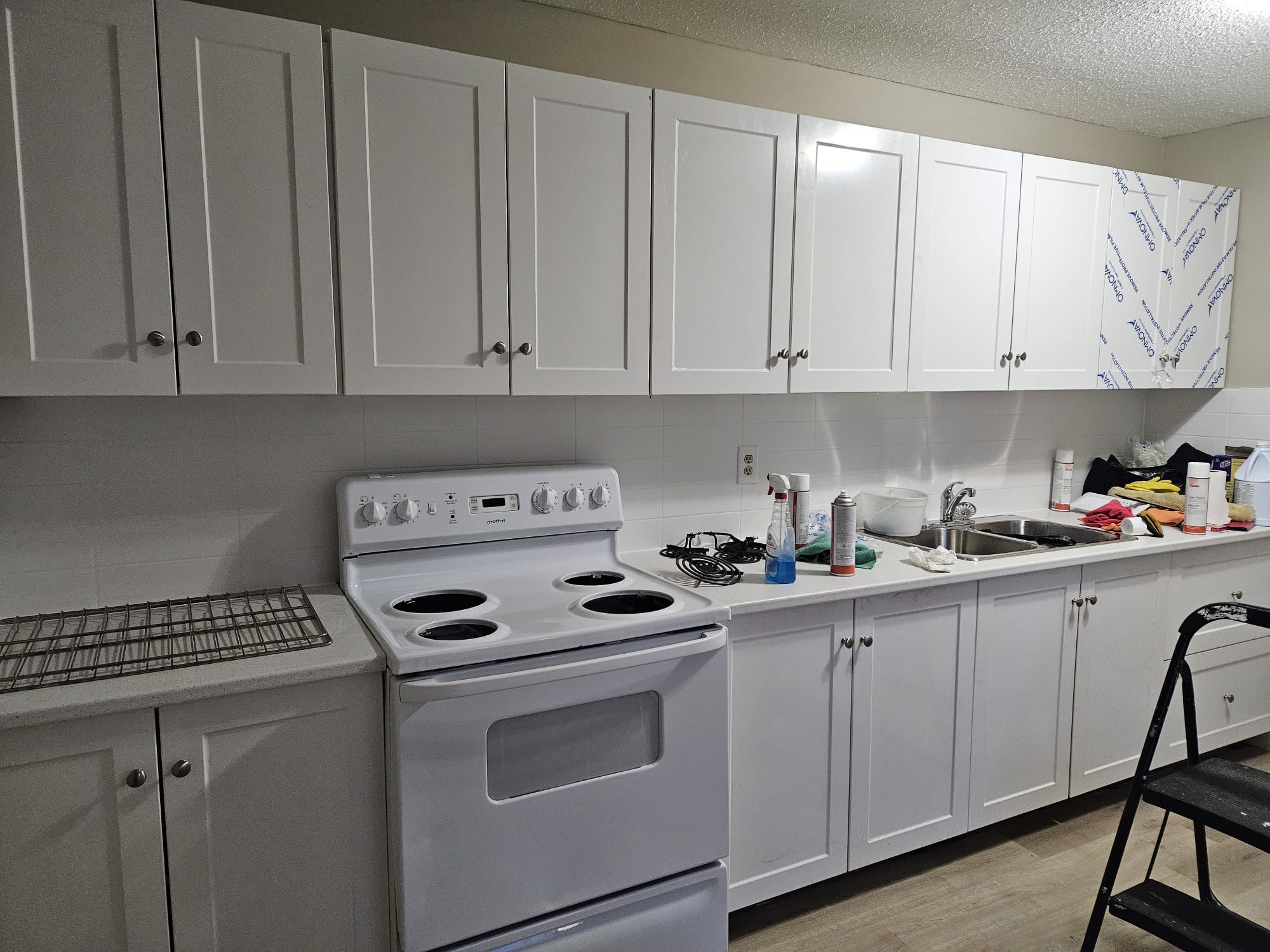 Kitchen flooring renovation in NW Calgary — large format porcelain replacing old tile