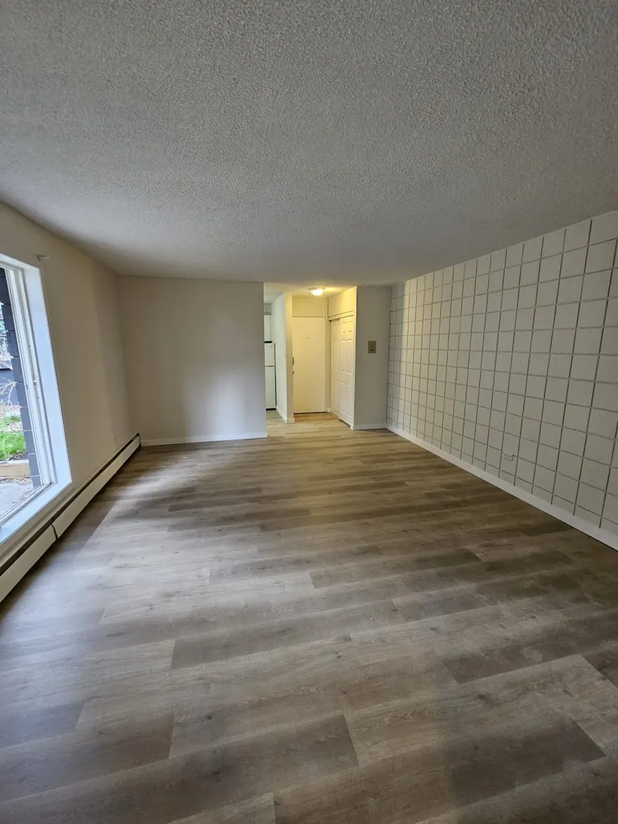 Basement suite renovation in Airdrie — new LVP flooring and baseboards throughout