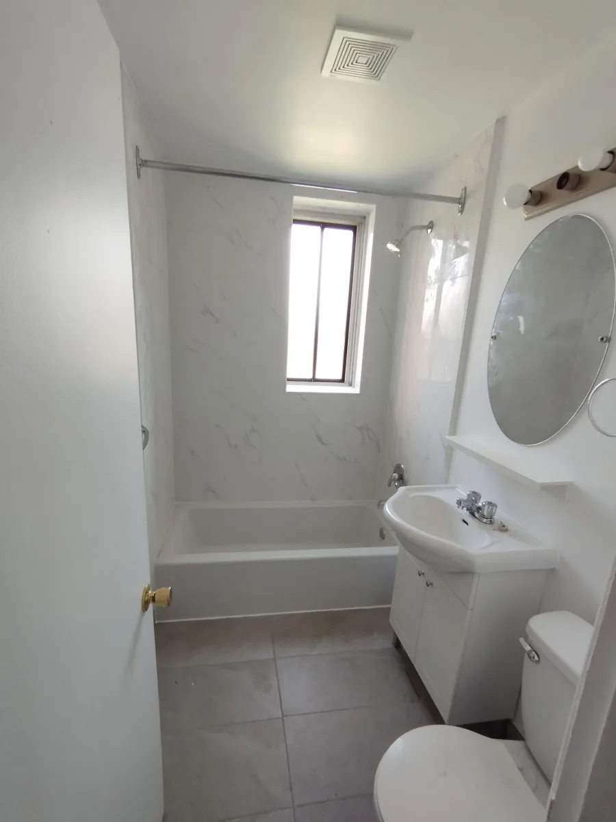 Bathroom tile renovation in SW Calgary — floor and wall tile with Schluter trim